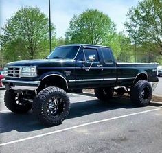 a large black truck parked in a parking lot