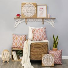 a bed with pillows, blankets and other decorative items on top of the headboard