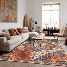 a living room filled with furniture and a large rug on top of a hard wood floor