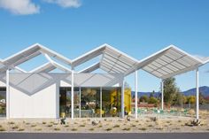 the building has three large white awnings over it