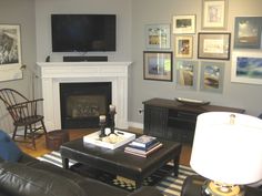 a living room filled with furniture and a flat screen tv mounted on the wall above a fire place