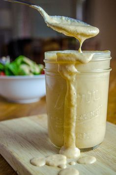 a jar filled with liquid sitting on top of a wooden table