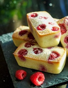 raspberry shortbreads with powdered sugar are piled on top of each other