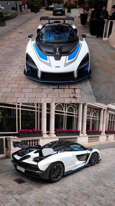 two different views of a white and blue sports car parked in front of a building