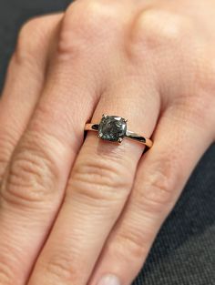 a woman's hand with a diamond ring on it