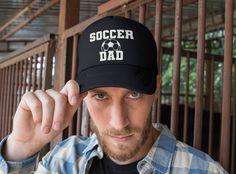 "This listing is for a Soccer hat for Dad. The Dad Cap is a staple in any outfit, your dad can dress up or down. This unstructured cap allows effortless style and comfort. DETAILS: ➤ One size fits all hat with a custom embroidered design. ➤ Dad caps have a curved visor and a buckle strap closure with grommet. ➤ Snapback hats have a flat visor and snapback closure for easy sizing. ➤ Hats come in four colors: Black, Dark Grey, Navy, and White. ➤ Printed, Packaged and Shipped From The USA. Support Viking Logo, Viking Beard, Soccer Gifts, Cap Designs, Dad Cap, Holy Cow, Sports Caps, Dad Caps, Dad Hat