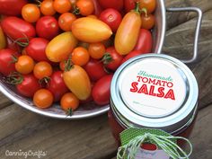 tomatoes and tomato sauce in a metal bowl next to a tin can with label on it