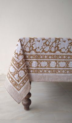 a table with a brown and white cloth on it