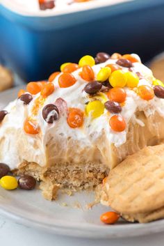 a desert with cookies and candy on it sitting on a plate next to a cookie