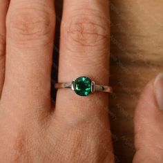 It is a lab emerald ring. The main stone is 7 mm*7 mm round cut.weight about 1.30 carats. The basic metal is sterling silver and plated with rhodium/14k white gold/14k rose gold/14k yellow gold You can also go to my shop Home for more elegant rings: https://www.etsy.com/shop/godjewelry?ref=hdr_shop_menu Customization is always welcome and please feel free to contact with me if you have any design ideas! Sterling Silver Emerald Ring With Bezel Setting, Solitaire Round Emerald Ring For Promise, Anniversary Emerald Ring, May Birthstone, Round Cut, Round Solitaire Emerald Promise Ring, Anniversary Emerald Ring For May Birthstone In Round Cut, Anniversary Emerald Ring For May Birthstone, Round Cut, Anniversary White Gold Emerald Ring With Bezel Setting, Silver Emerald Ring With Bezel Setting, Emerald Bezel Setting Birthstone Ring For May