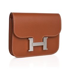 Guaranteed authentic Hermes Constance Slim Wallet Belt bag featured in classic Gold. Crisp Palladium hardware.Evercolor leather has a rich flat grain.Includes removable zipped change purse and 2 credit card slots.Rear belt loop allows you to wear it on variety of width belts.Fits up to a 42mm Hermes belt.Epsom leather.Comes with sleeper and signature Hermes box.NEW or NEVER WORN. final saleBAG MEASURES:LENGTH 4.9"TALL 4"DEEP 1.2"CONDITION:NEW or NEVER WORN Hermes Constance Slim, Constance Slim Wallet, Wallet Belt, Hermes Belt, Hermes Constance, Hermes Box, Change Purse, Slim Wallet, Classic Gold