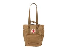 Fjallraven Kanken Totepack - Tote Handbags : Clay : The Fjällräven Kånken Totepack is functional and versatile enough to take anywhere, transforming from a tote, to a backpack with ease when changing commute options or walking around the supermarket. Waterproof G-1000 HeavyDuty Eco S fabrication keeps your stuff dry all-day long. Main compartment can hold all your daily essentials. Interior lined with a padded base for tablets. Zippered top main compartment opening. Front zippered compartment fo Casual Backpack With Top Carry Handle, Casual Daily Use Backpack With Top Carry Handle, Casual Outdoor Bags With Adjustable Straps, Fjallraven Kanken Totepack, Kanken Totepack, Fjällräven Kånken, Zipper Top, Daily Essentials, Fjallraven Kanken