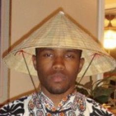 a man wearing a straw hat in a room