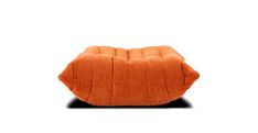 an orange cushion sitting on top of a white surface