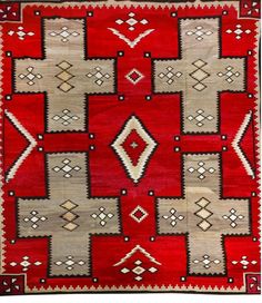 a red and beige rug with many different designs on the front, one is square