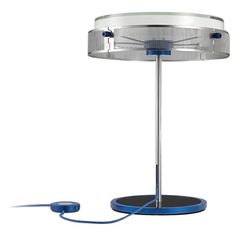 a table lamp with a blue cord attached to the base and a white light behind it