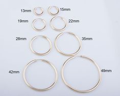 six pairs of silver hoop earrings size guide for sizes and measurements on a white background