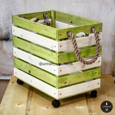 a wooden crate with rope in it sitting on top of a piece of plywood