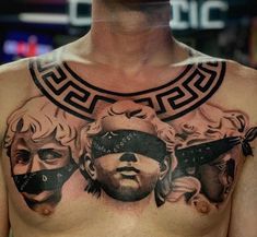 a man with tattoos on his chest has two men wearing blindfolds and masks