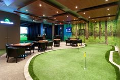 an indoor golf course with tables and chairs