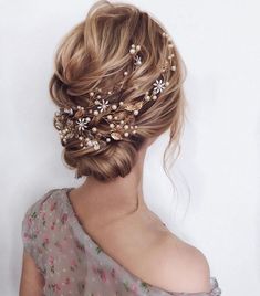 a woman wearing a hair comb with flowers on it