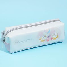 a white pencil case with embellishments on the front and bottom, sitting on a blue background