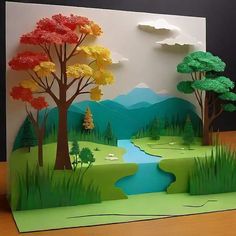 an image of a card with trees and water in the background on a wooden table