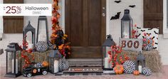 halloween decorations on the front door of a house with pumpkins and hay bales