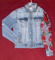 a denim jacket with flowers on it