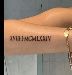 a woman's arm with roman numerals on it