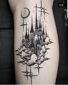 a black and white photo of a castle tattoo on the right side of the leg