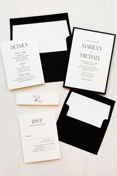 three black and white wedding stationery with matching envelopes