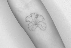 a single flower tattoo on the arm