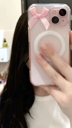 a woman taking a selfie with her cell phone case in front of her face