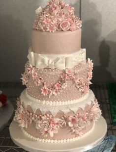 a three tiered wedding cake with pink flowers on top