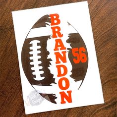 a close up of a sticker on a wooden table with a football and the words brandon