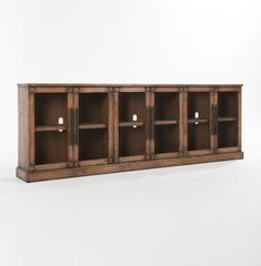 an old wooden cabinet with four doors and three shelves on each side, in front of a white background