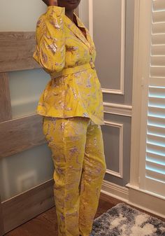 A bold yellow suit with a metallic floral pattern, brocade fabric featuring a fitted jacket with a slight peplum and matching straight-leg pants. Made to order Spring Evening Peplum Set, Spring Party Peplum Set, Spring Party Sets With Peplum Shape, Elegant Yellow Pantsuit For Spring, Elegant Fitted Yellow Pantsuit, Elegant Yellow Pantsuit For Formal Occasions, Spring Formal Yellow Set, Yellow Long Sleeve Pantsuit For Spring, Yellow Long Sleeve Spring Pantsuit