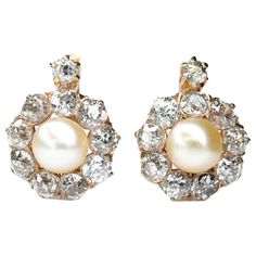 An adorable pair of cluster earrings feature lustrous natural pearls wrapped with a scalloped diamond border in 18 karat yellow gold. Sweet as can be. Circa 1900. Perfect Condition Diamond: 2.1ct Weight: 4.7g Length: 18mm Width: 12mm Size of pearl: 6mm We have many other fantastic pieces of antique and vintage jewelry listed on our 1stDibs store, so please consider browsing our other pieces. Diamond Cluster Earrings, Platinum Earrings, Platinum Diamond Rings, Pearl And Diamond Earrings, Gold Pearl Earrings, Diamond Brooch, Diamond Drop Earrings, Natural Pearl, Diamond Flower