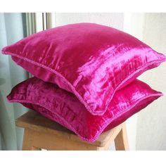 three pink pillows stacked on top of each other