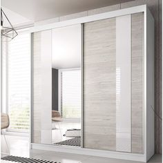 a white closet with sliding doors in a room