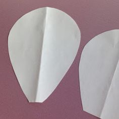 two pieces of paper are cut out to look like hearts