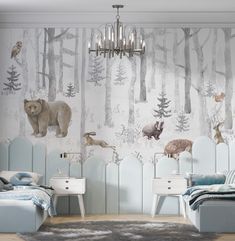 a bedroom decorated in pastel blue and white with bears, deers, and pine trees on the wall