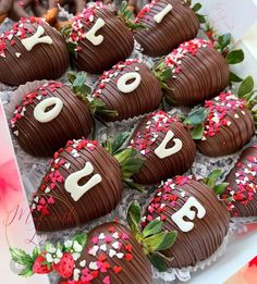 chocolate covered strawberries with the word love spelled on them