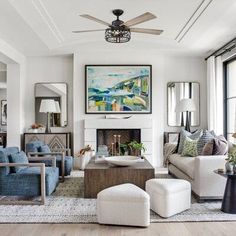 a living room with couches, chairs and a fireplace in the middle of it