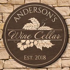 a wooden sign that says anderson's wine cellar est 2018 on the side of a stone wall