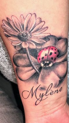 a ladybug sitting on top of a flower with the word mylene written below it