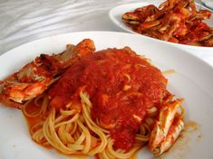 a plate of spaghetti with shrimp and sauce on the side, next to another plate of pasta