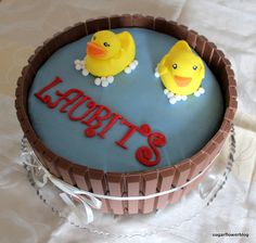 there is a cake with two rubber ducks on it