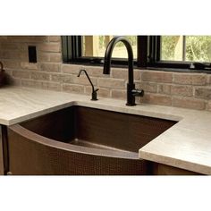 a kitchen sink with an apron style faucet